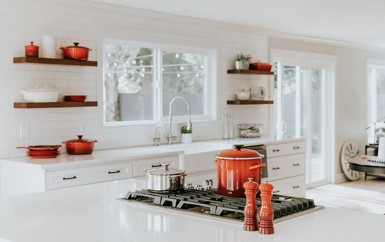 https://www.decasacollections.com/wp-content/uploads/2022/10/Kitchen-Counter-Decor-Ideas-14-Creative-Tips-6th-Image-White-kitchen-interior-with-pops-of-color-red.jpg