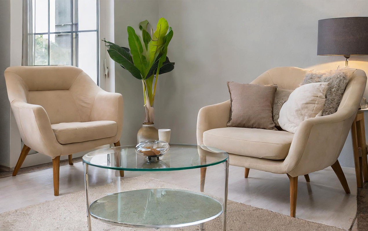 Living room nook with neutral chairs and tiered furniture