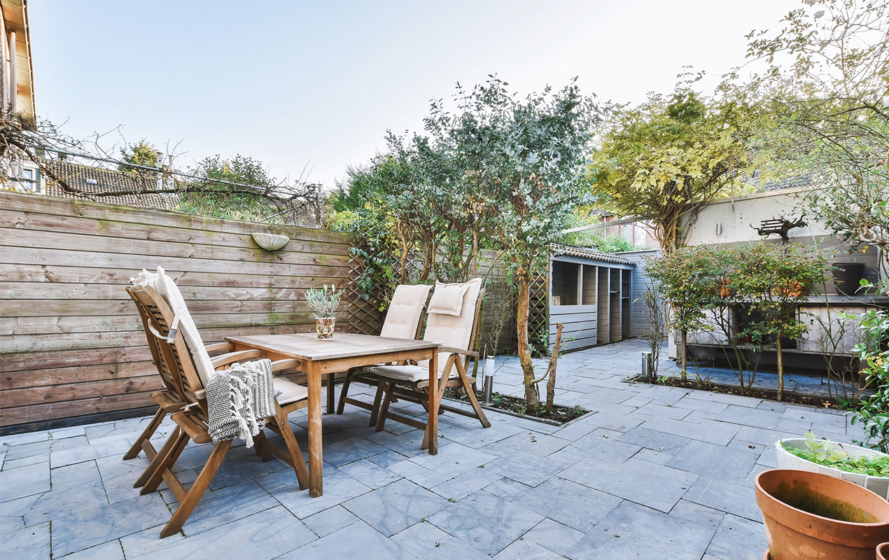 Backyard setup with patio furniture chairs and dining table