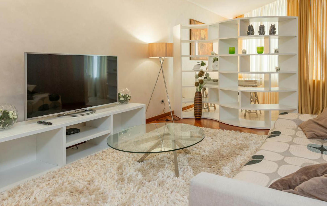 Home interior with white furniture and floor rug