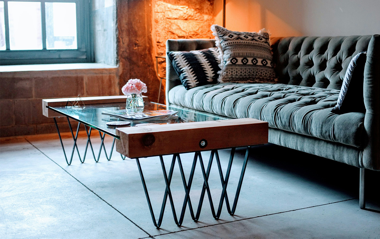 Rustic home interior with tufted velvet sofa.