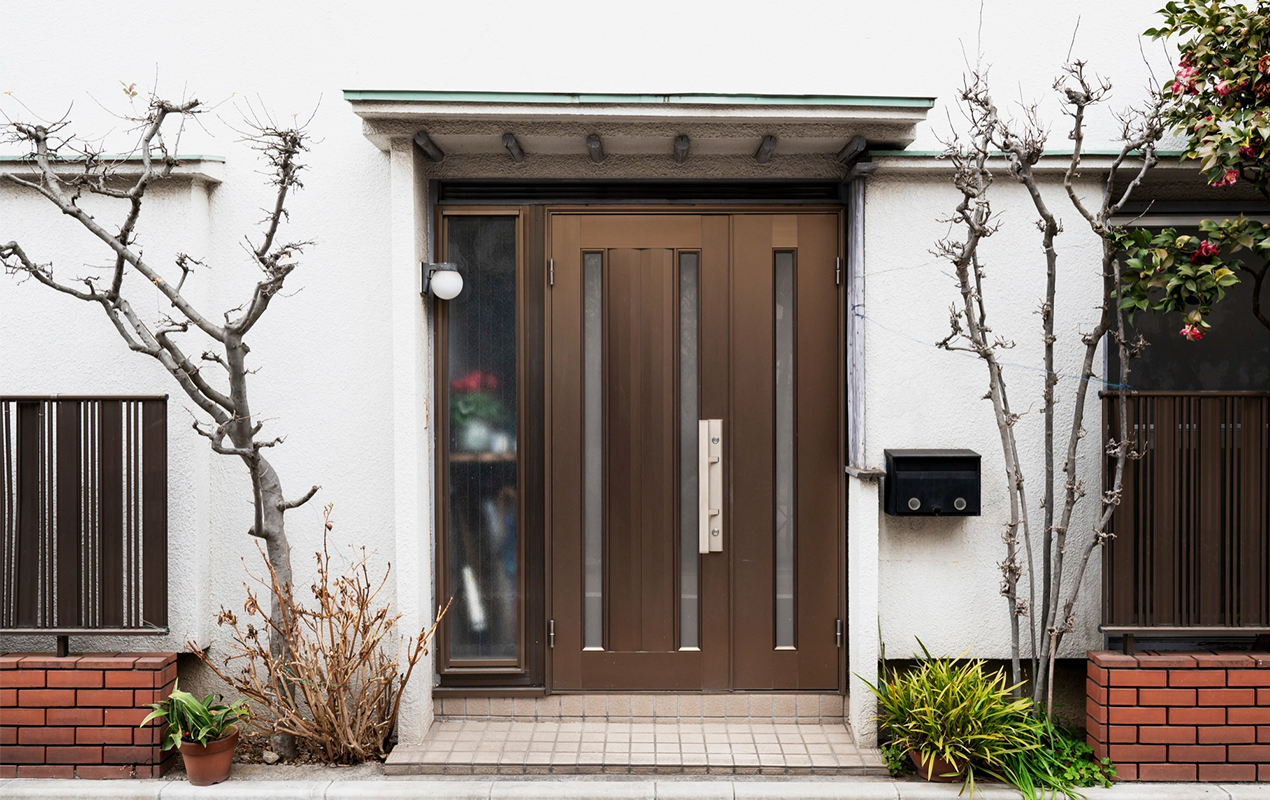 white house with brown double doors