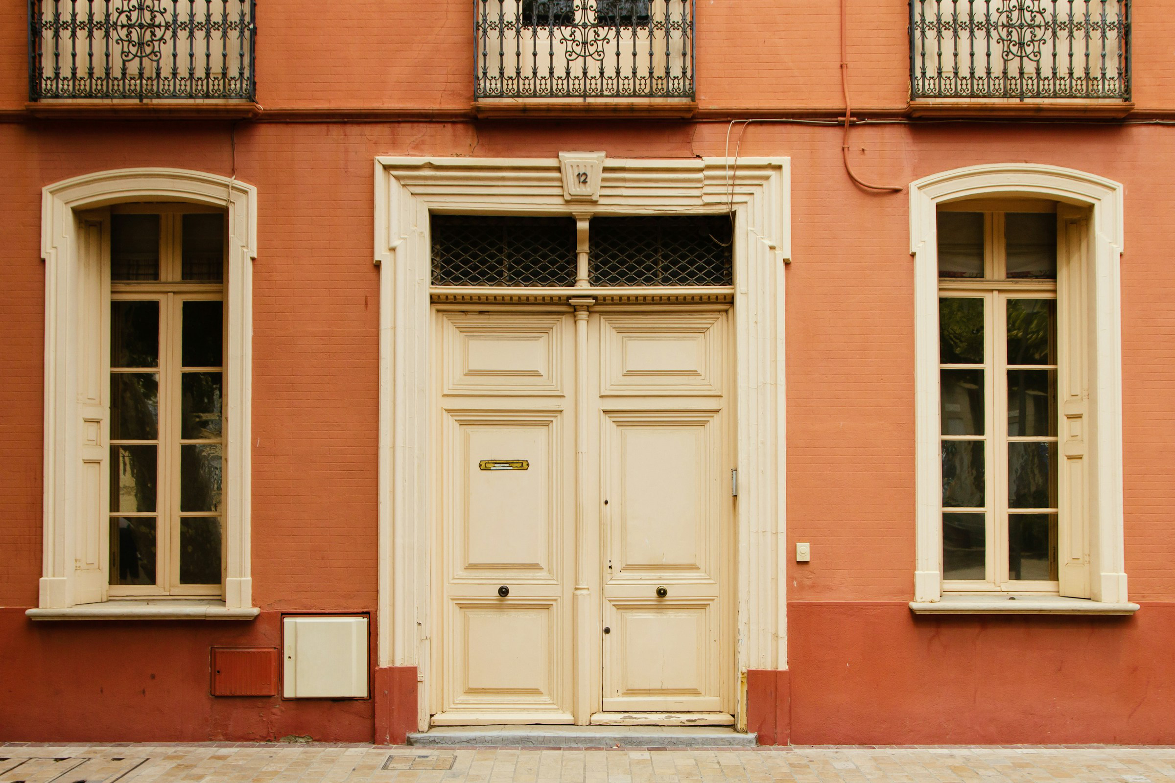 Terracotta house with off white doors 