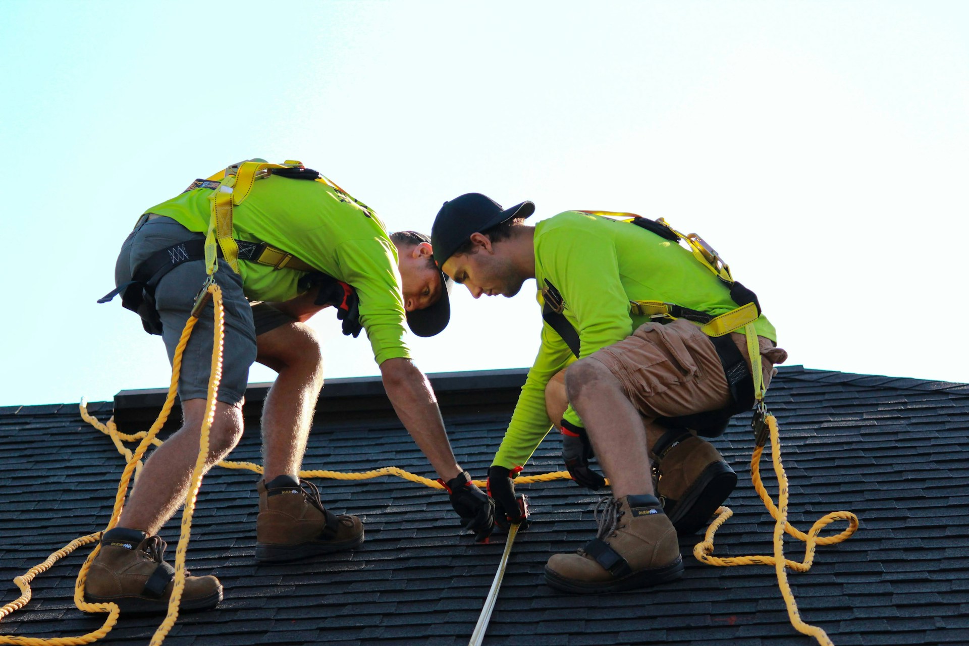 Two men working on a house roof